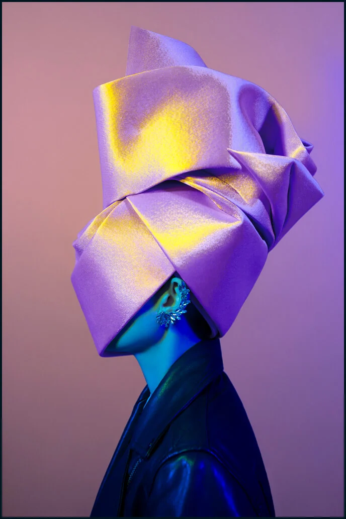 Metamorphoses Envoy portrait with a folded violet headpiece and blue light